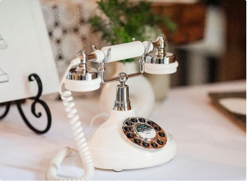 Ivory rotary audio guestbook phone styled on a wedding guestbook table