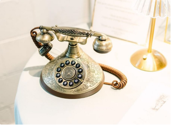 Ornate brass rotary audio guestbook phone used as a wedding focal point